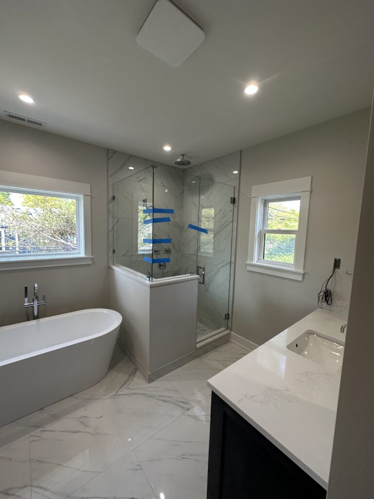 A modern, minimalist bathroom with sleek fixtures and a freestanding bathtub