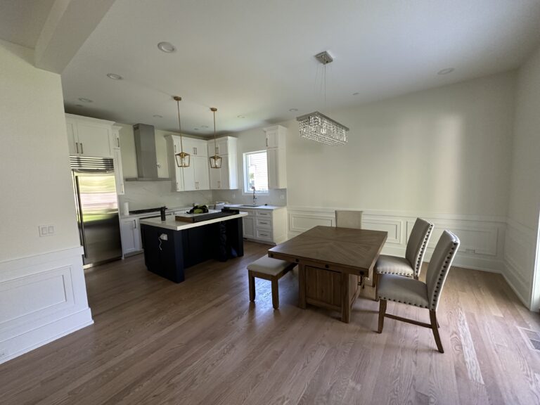 Beautifully transformed kitchen and dining area with an open concept, modern appliances, and elegant fixtures, perfect for family gatherings.