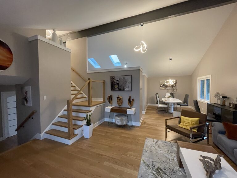 Contemporary lounge area with hardwood floors and natural light