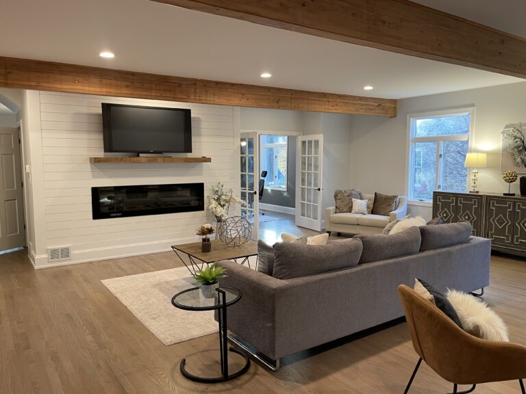 Living room with a wall-mounted TV and cozy furnishings